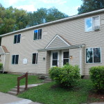 a white house with a yard in front of it